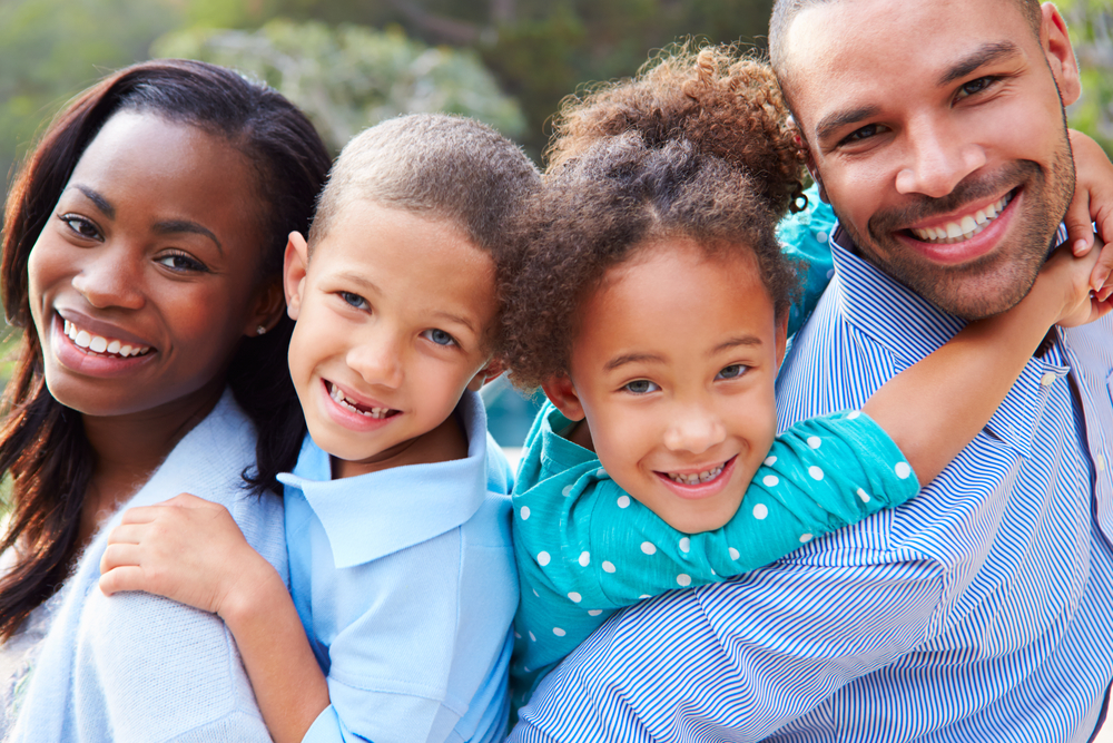 Happy family smiling after a dental checkup in Clemson, SC